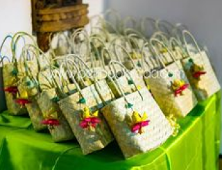 Customized bags filled with symbolic gifts for guests' blessings.